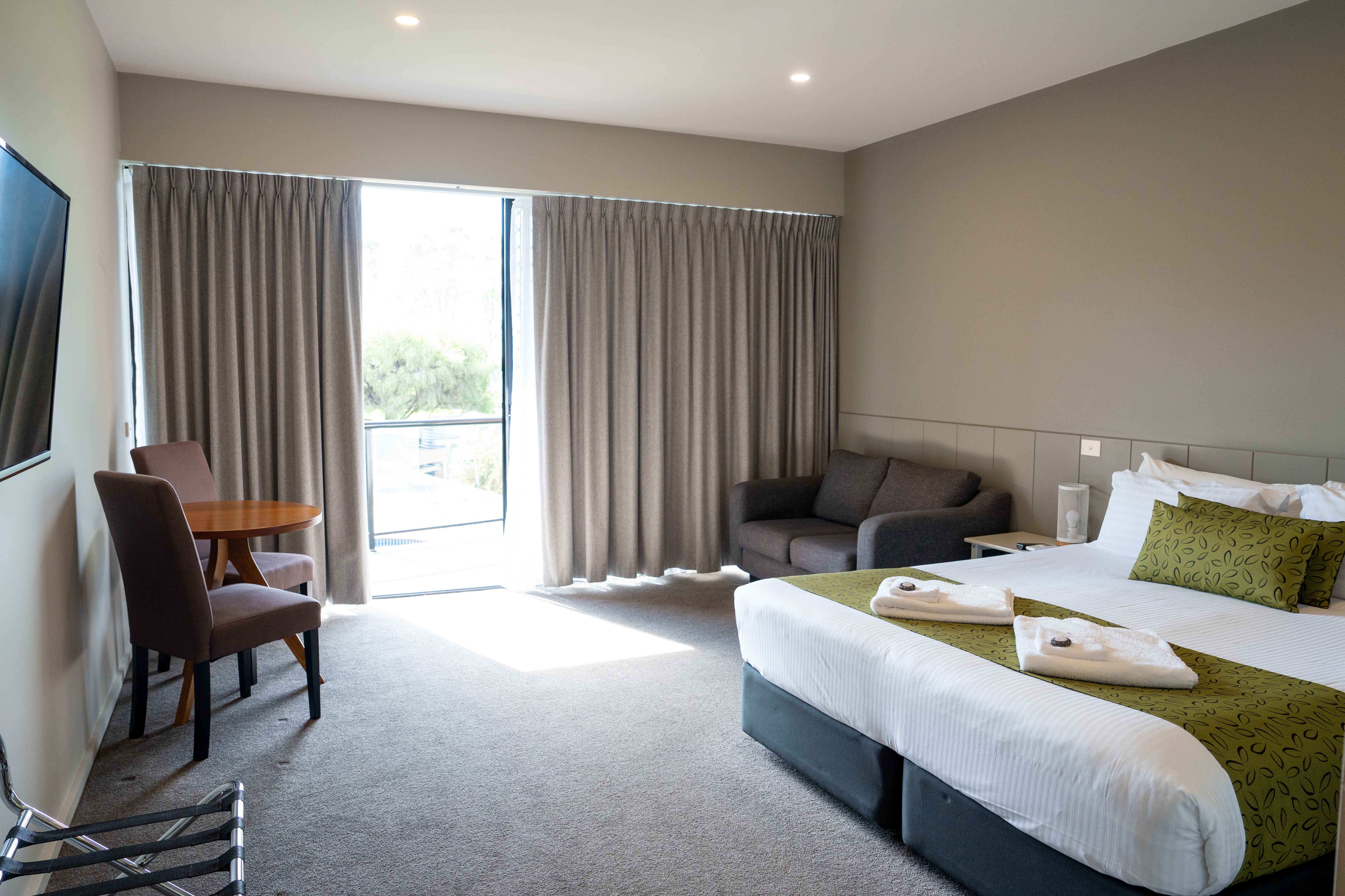 clubmulwala-resort-room-king-bed-window-view.jpg